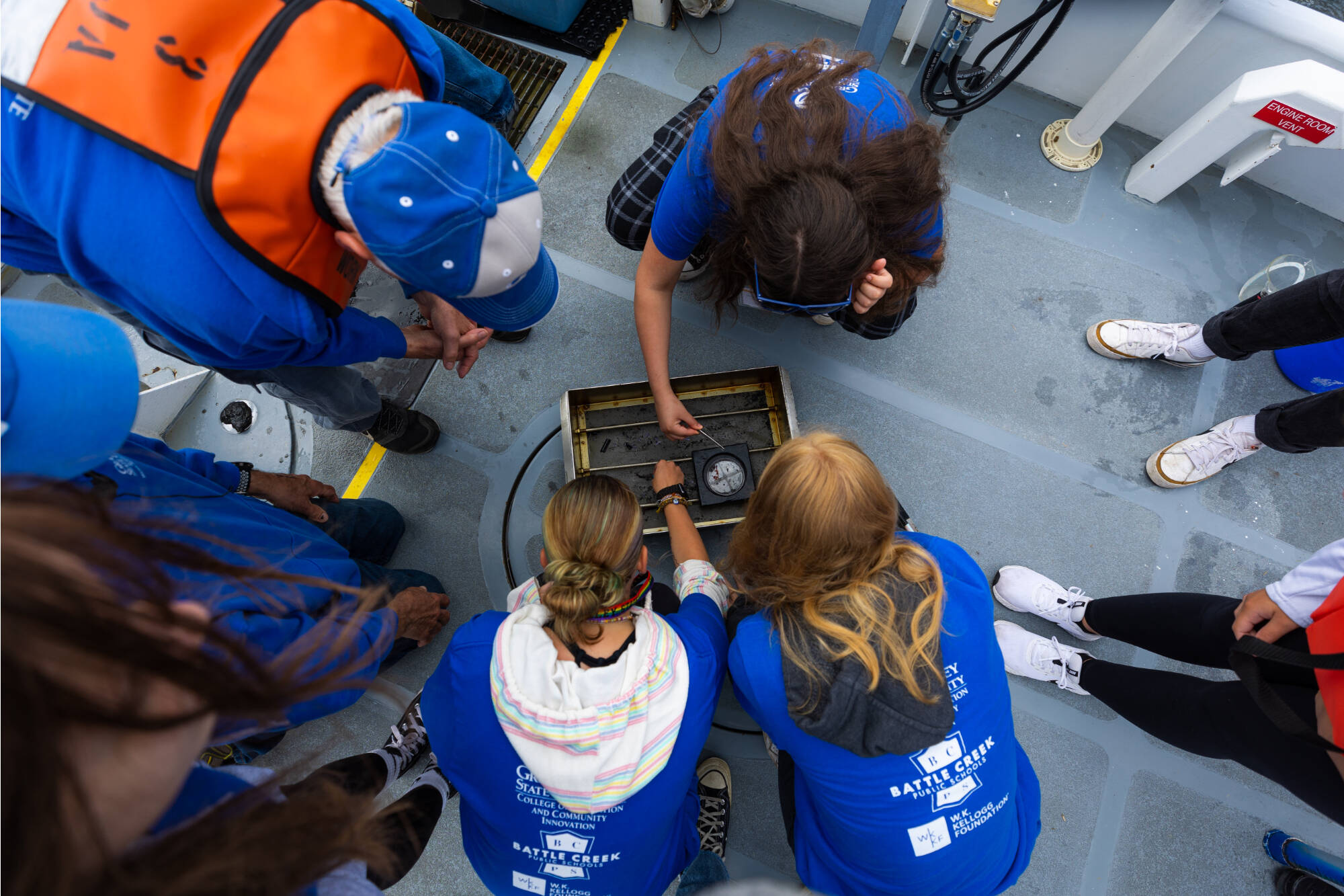 Students search for benthic organisms from the bottom of Spring Lake onboard the D.J. Angus research vessel.
